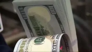 A Close-Up of Rolled $100 Bills Representing Iowa's Economy