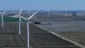 Iowa’s Wind Energy Industry Shown with Large Wind Turbines on An Open Field