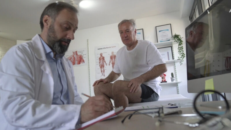 Doctor reviews an older patient’s condition at a medical appointment