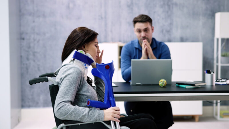 Injured worker in a wheelchair meets with a vocational rehabilitation counselor