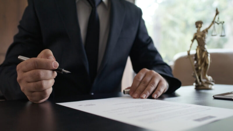 Workers’ compensation lawyer reviews a legal document at a desk